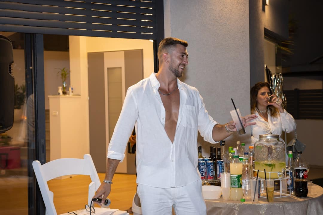 a man standing next to a woman at a table